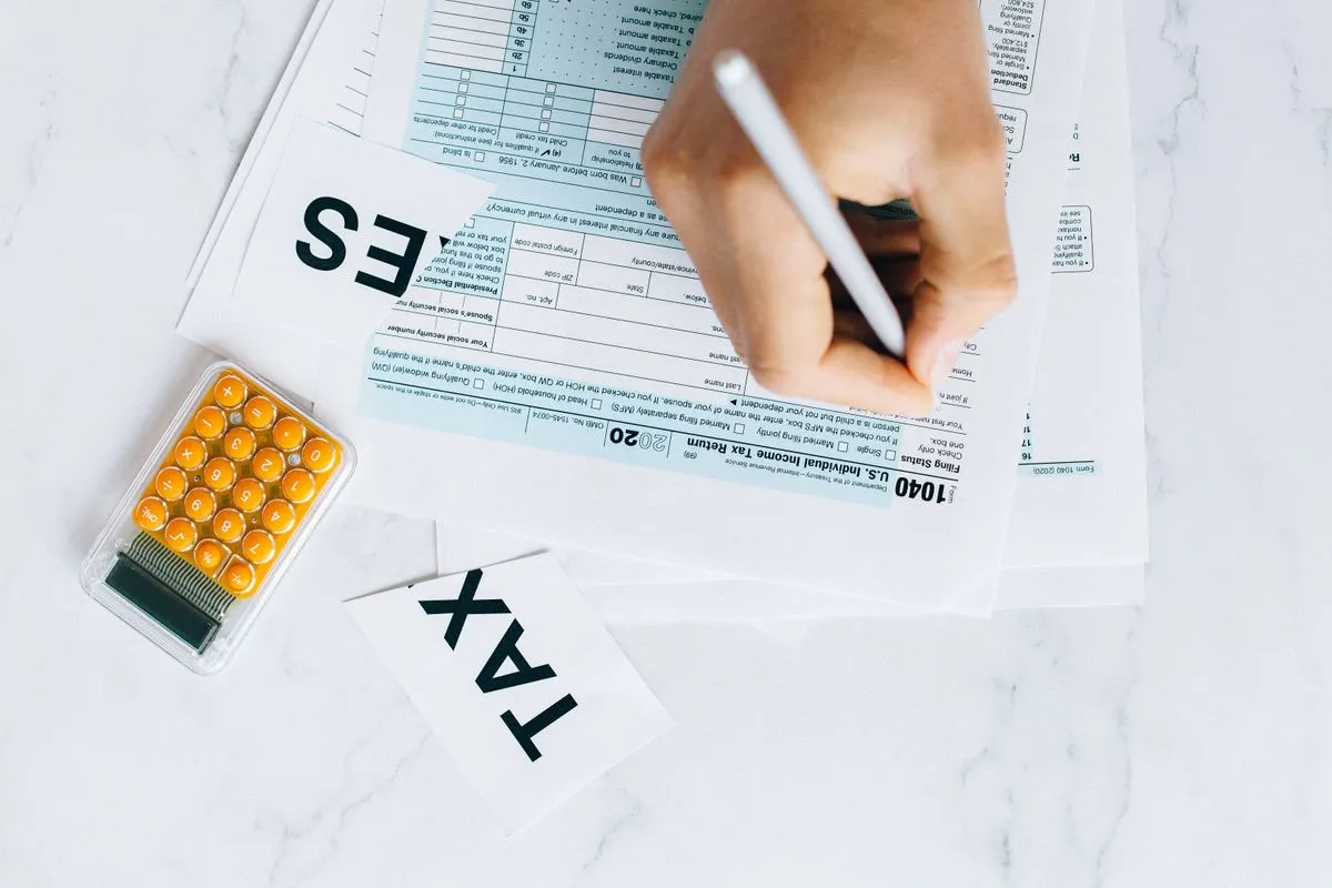 Accountant reviewing monthly financial statements on a laptop