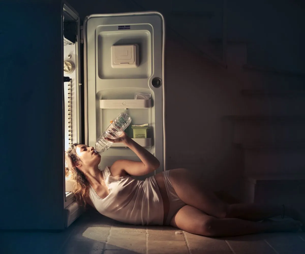 Technician performing refrigerator repair in a modern kitchen