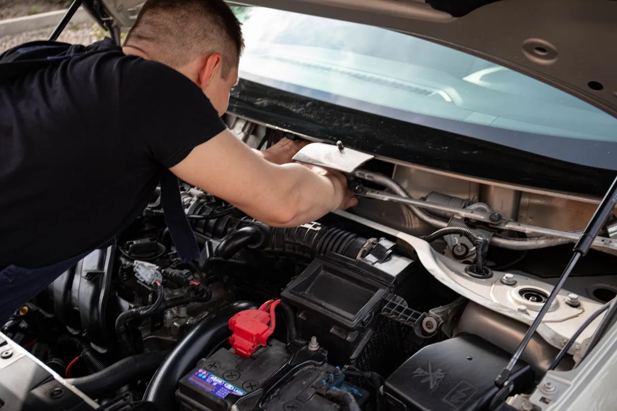 Close-up of car AC repair tools and manifold gauges