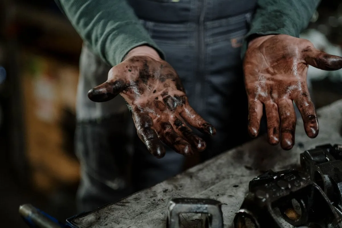 Technician completing a car oil and filter change on a sedan