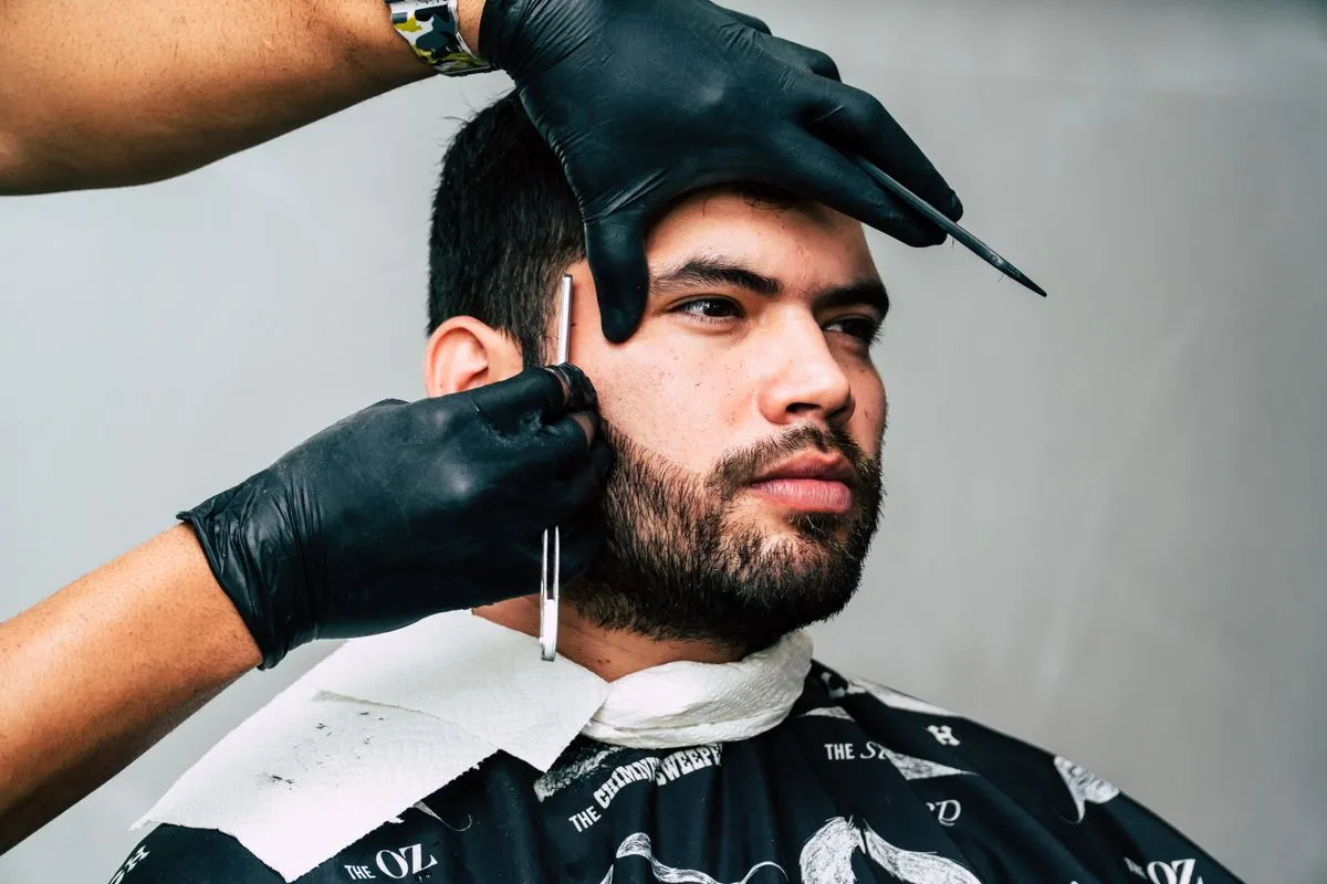 Barber preparing a hot towel shave for a client