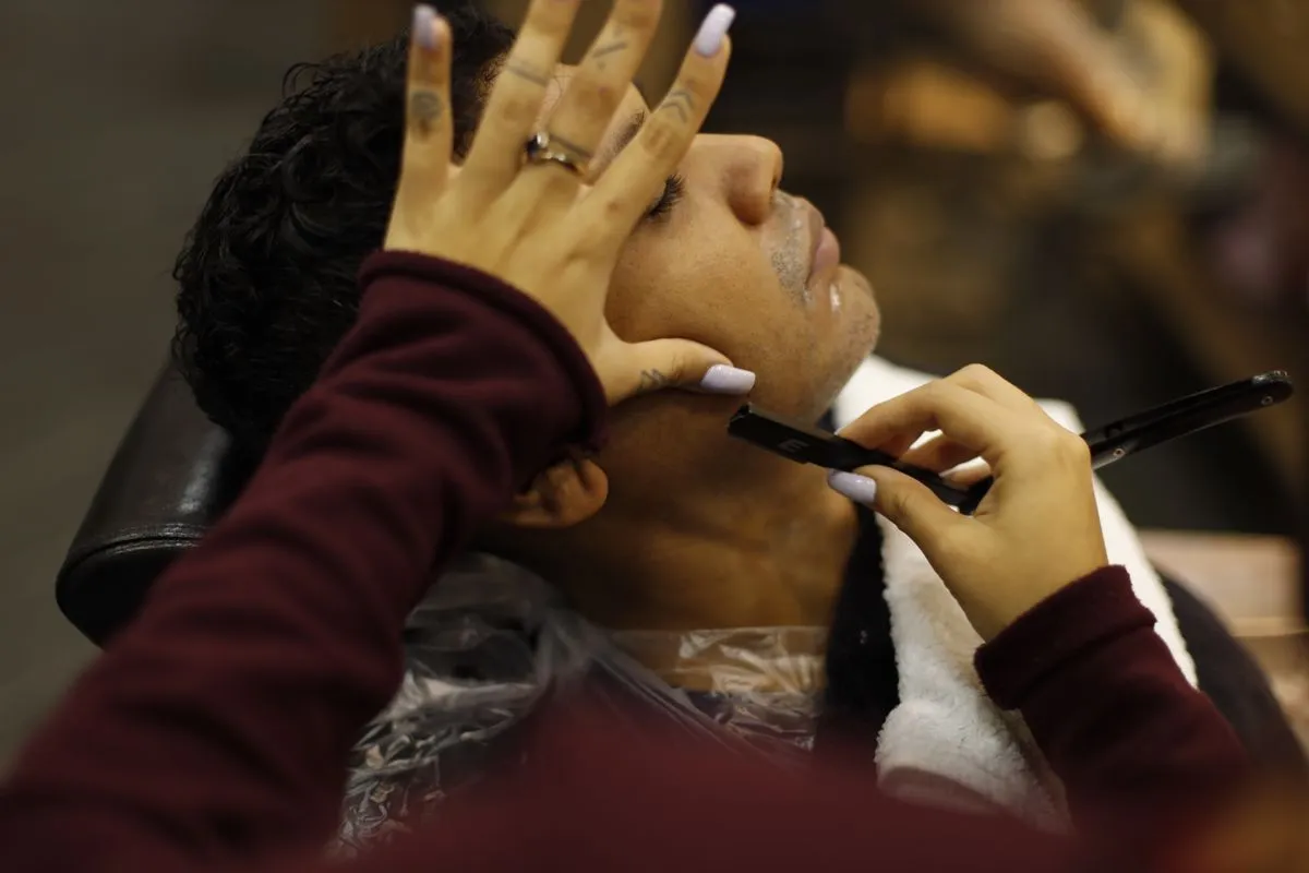 Barber preparing a beard trim and shave with hot towel shave tools