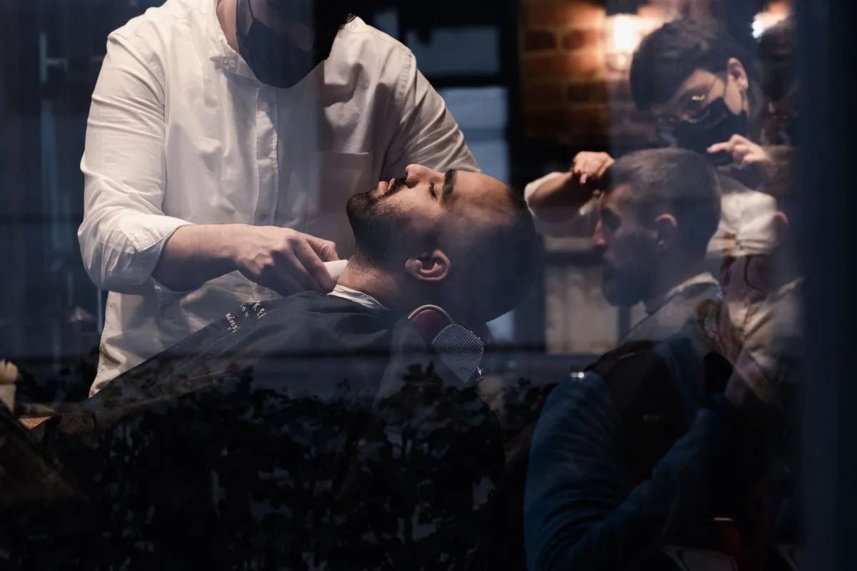 Barber finishing a classic men's haircut with scissors