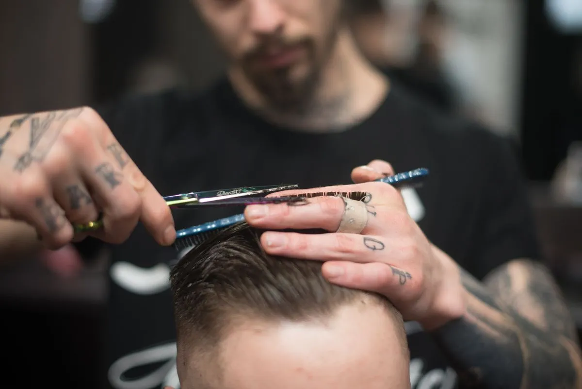 Client getting a men's haircut near me with a polished finish