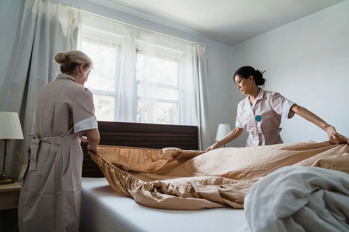 Neatly made bedroom and dust-free surfaces after a house cleaning service visit