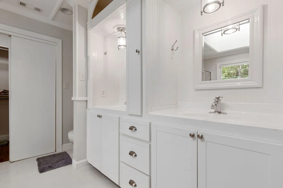Built in shelving wall with adjustable open shelves and lower cabinets