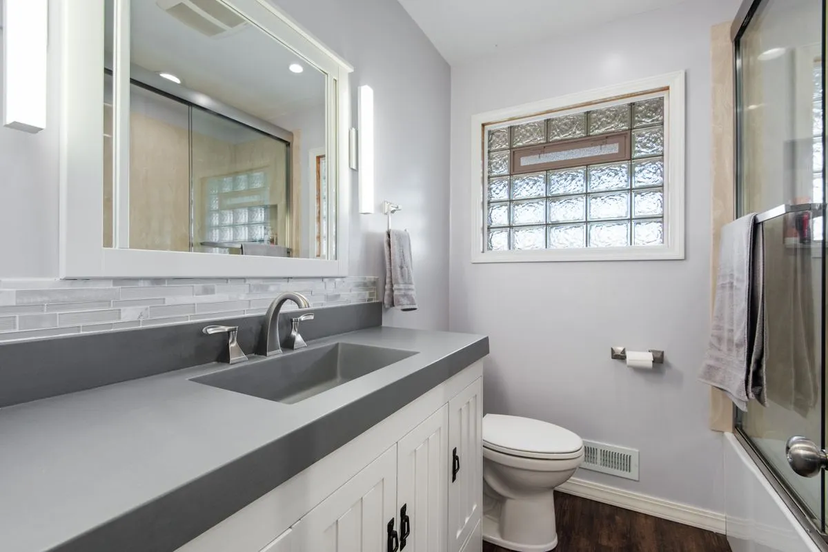 Custom bathroom vanity installation with premium hardware and stone top