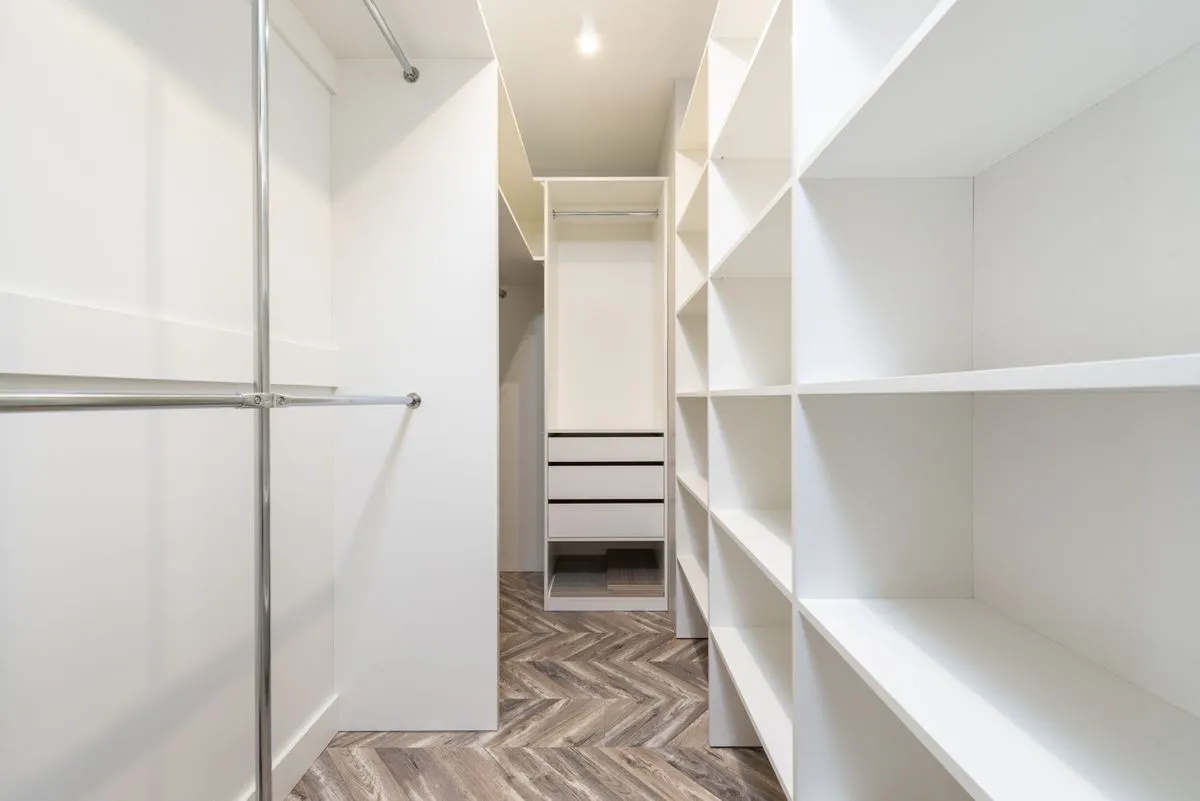Walk in closet design with double hanging sections and shoe storage