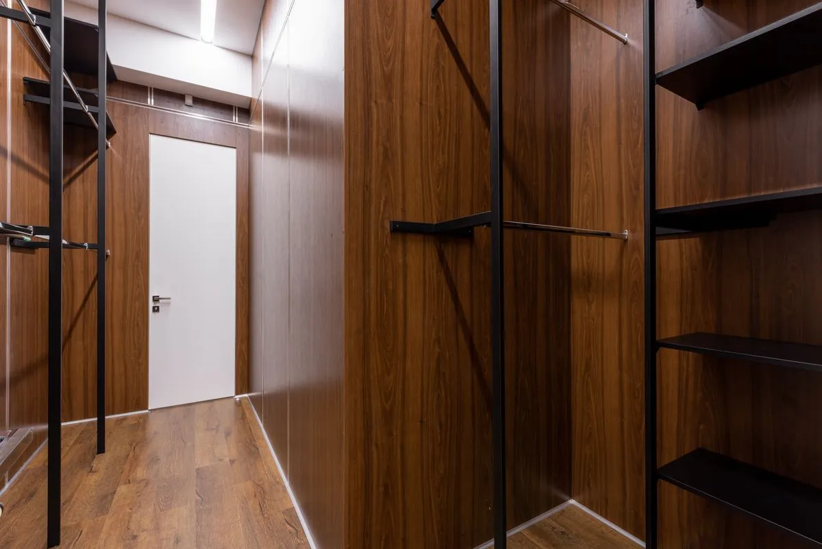 Luxury primary closet layout with drawers and accessory storage