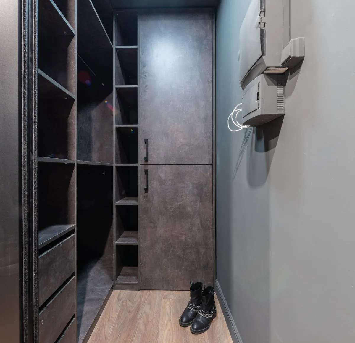 Spacious walk in closet design with wood accents and clean lines