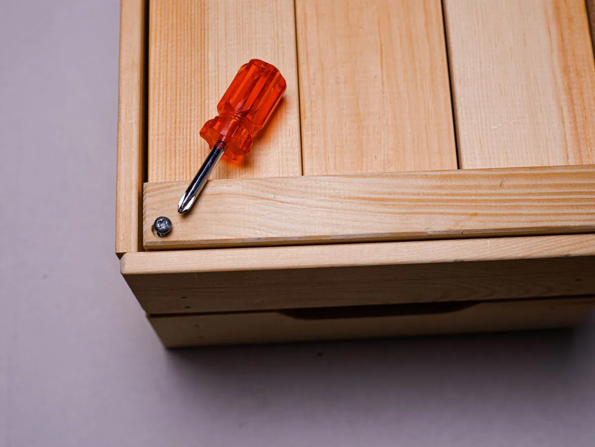Flat pack assembly of a home office desk with organized tools and hardware