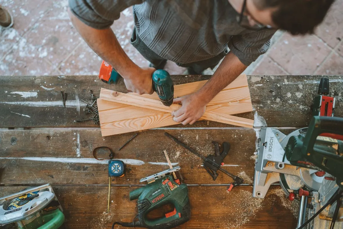 Technician completing furniture assembly service in a modern apartment