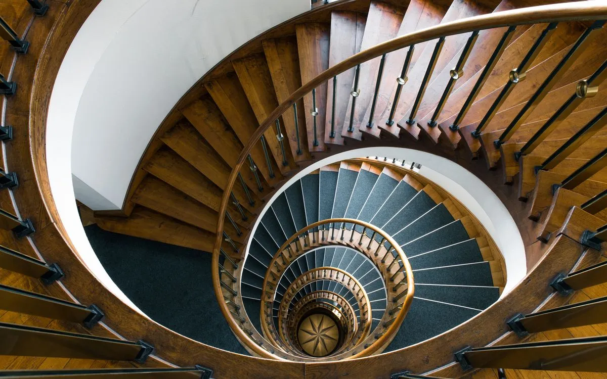 Hardwood stair installation with matching handrail and balusters in a modern home