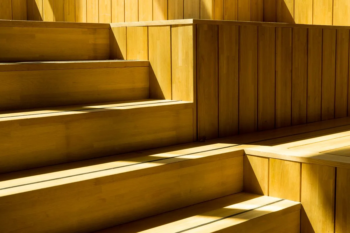 Elegant custom wood staircase view from the second floor landing