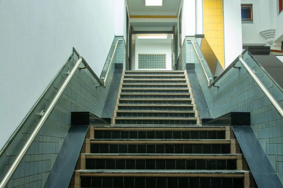 Matte black metal stair railing on a modern interior staircase