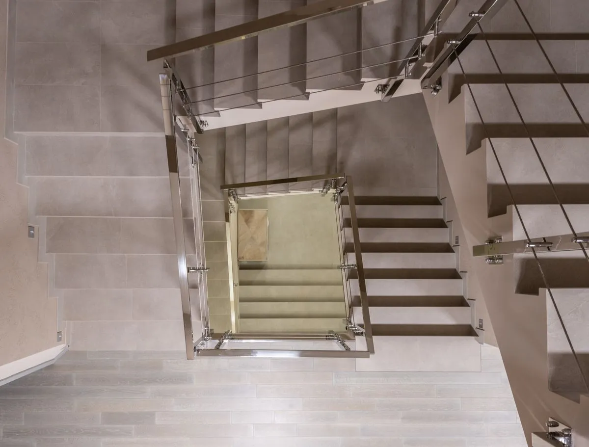 Exterior stair railing installation on a front porch in a suburban home