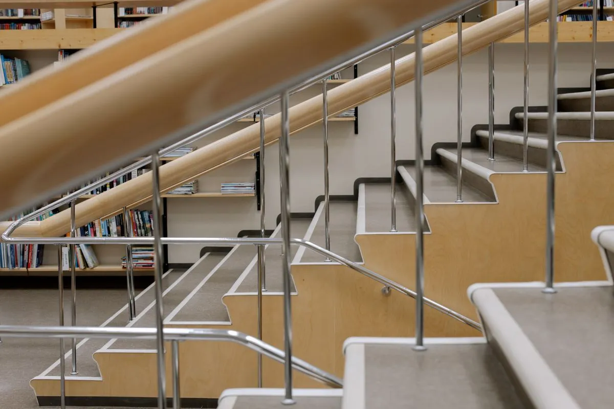 Custom metal stair railing with landing transition and welded posts