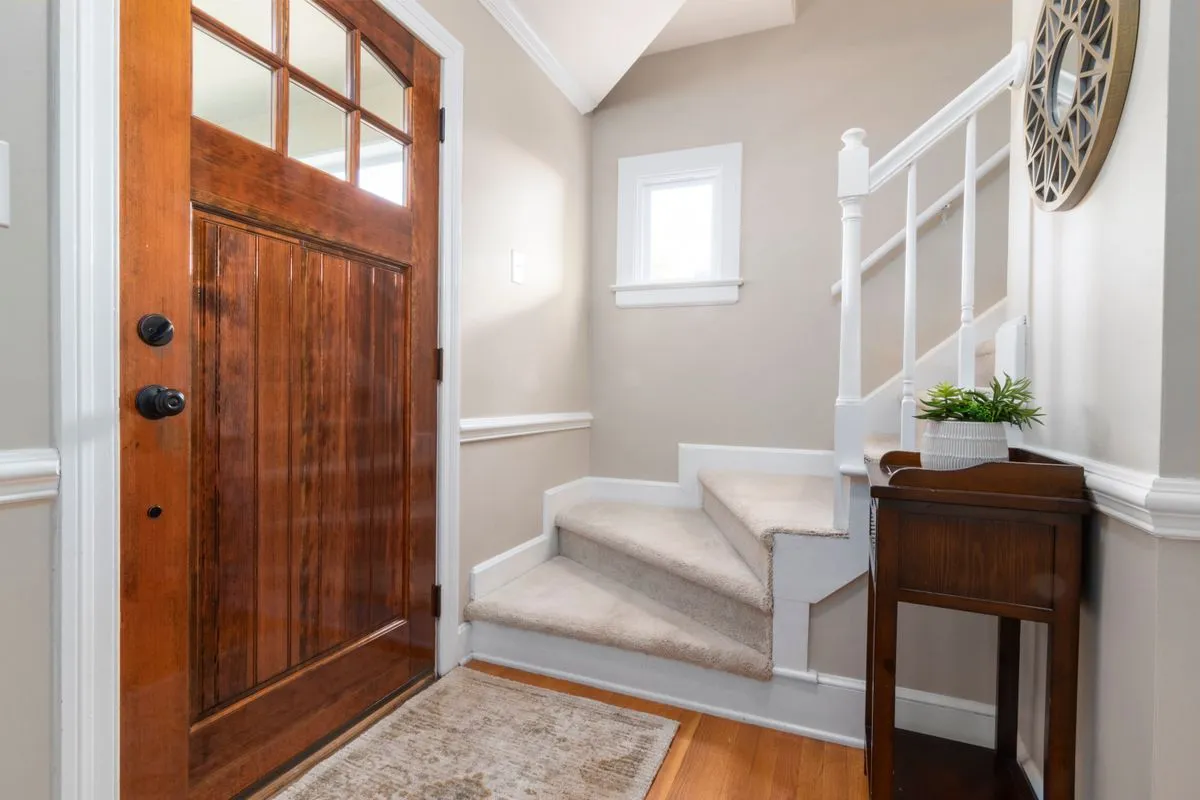 Technician performing entry door installation at a residential home
