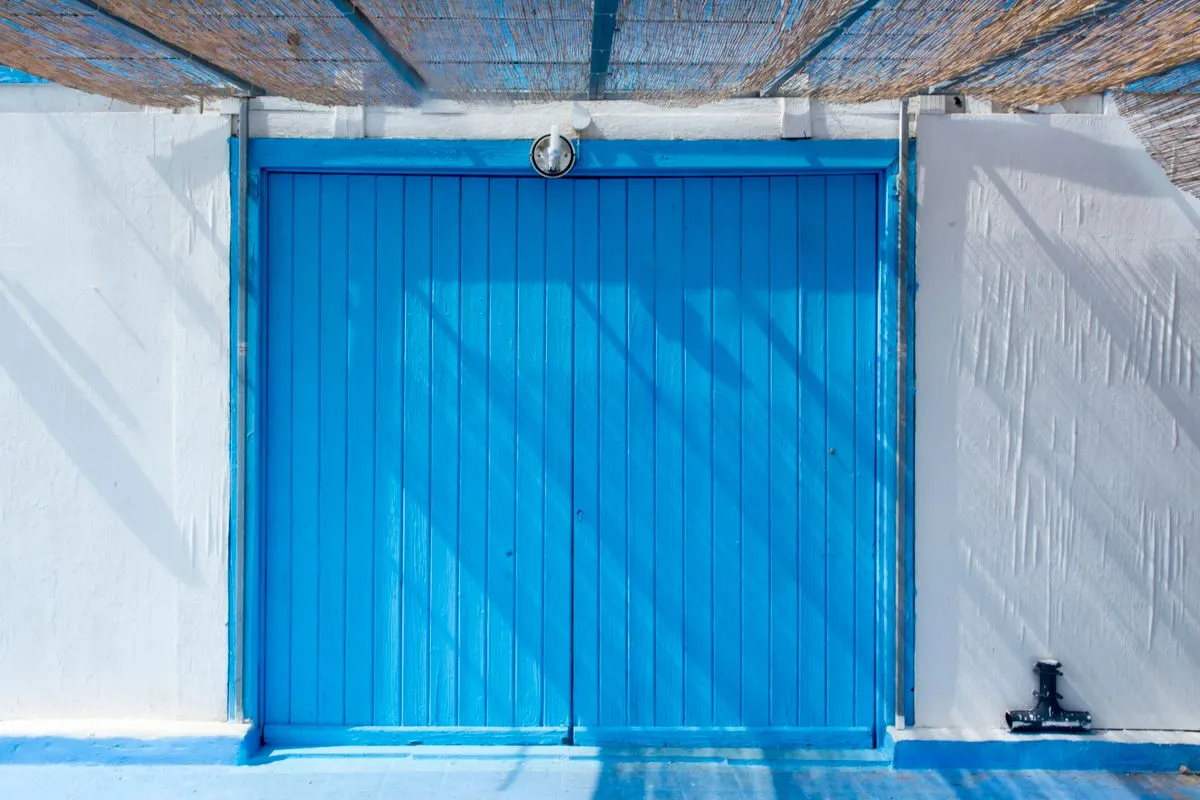 Before and after view of a garage door replacement completed by our crew