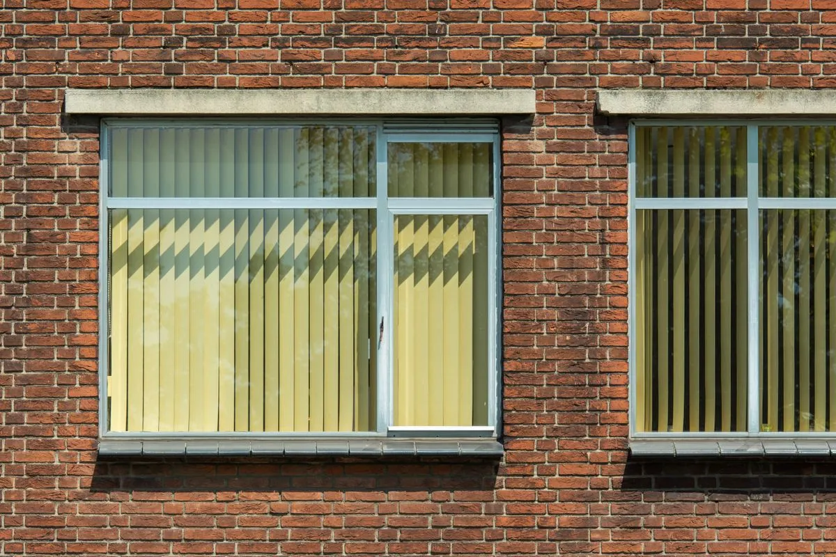 Before and after window replacement project on a two-story house