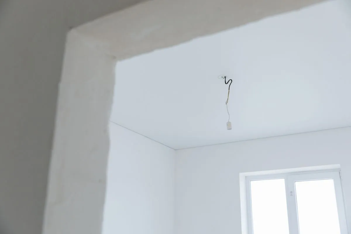 Water damaged ceiling repair after a bathroom leak with fresh finish work
