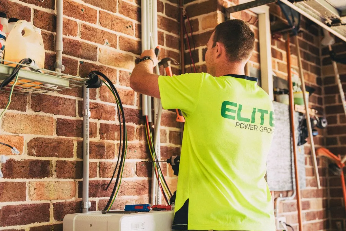 24 hour electrician repairing a damaged outlet in a kitchen