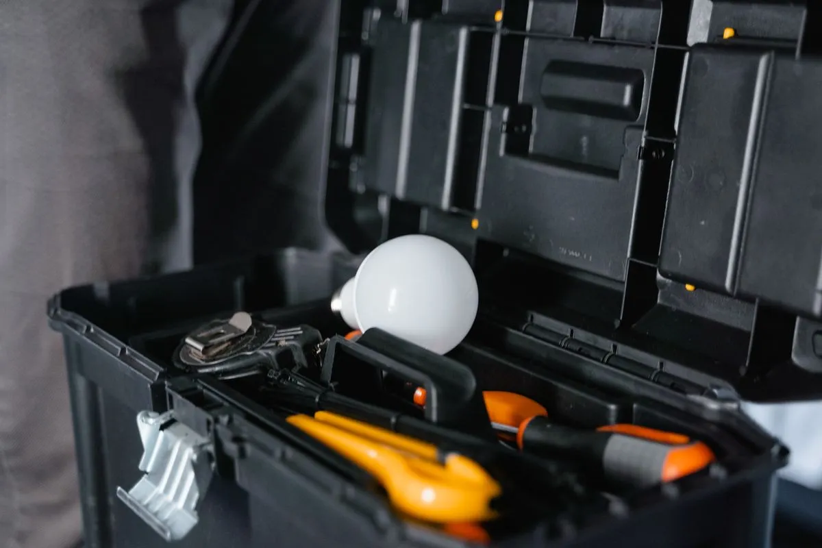 Electrical repair service technician testing a circuit with a multimeter