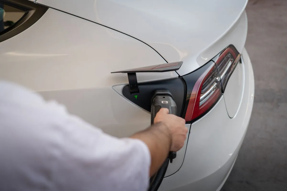 Technician performing EV charger installation in a home garage