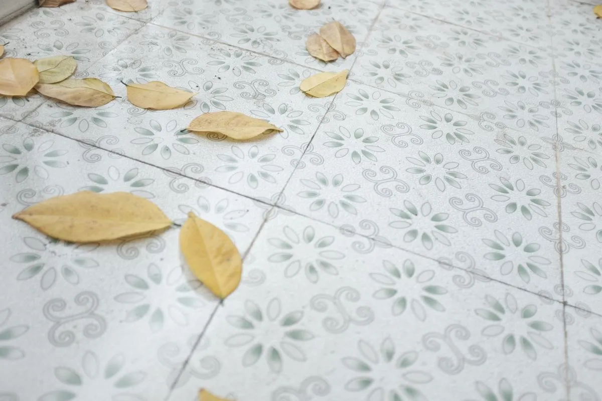 Homeowner laying large-format tiles on a bright bathroom floor