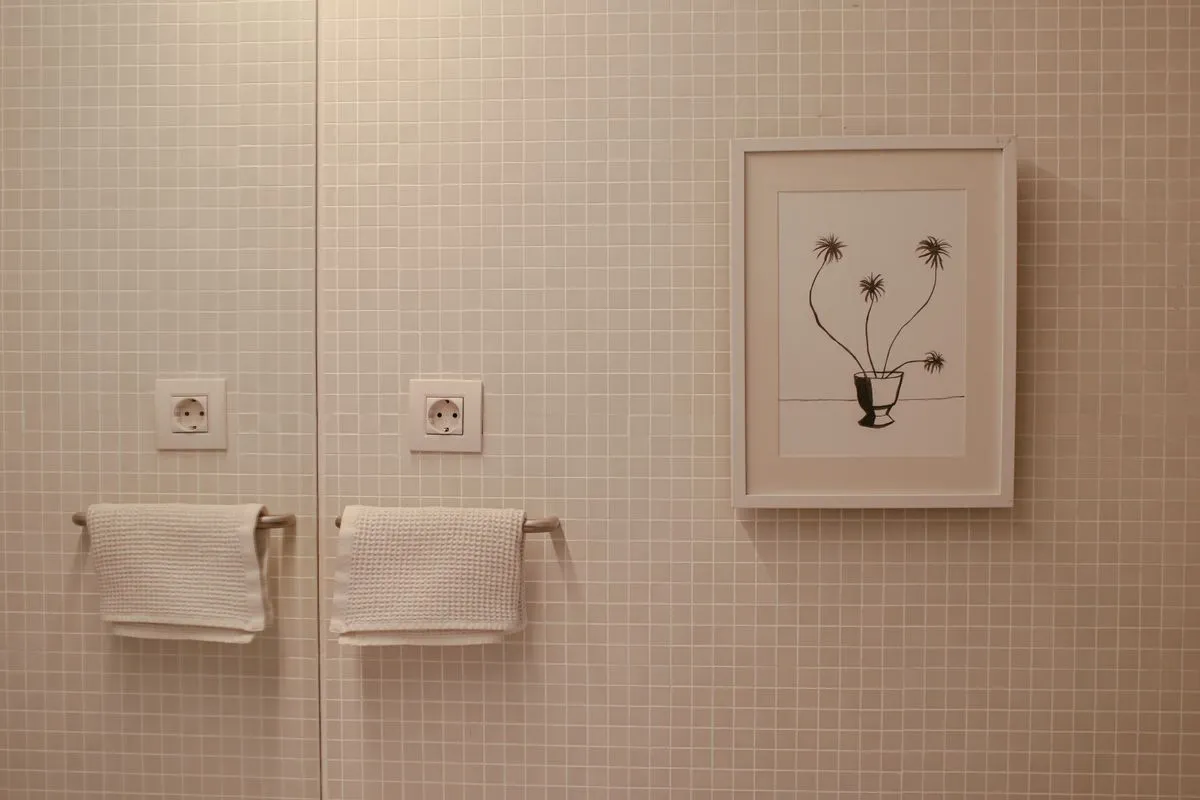 Large-format stone-effect tiles on a modern bathroom wall