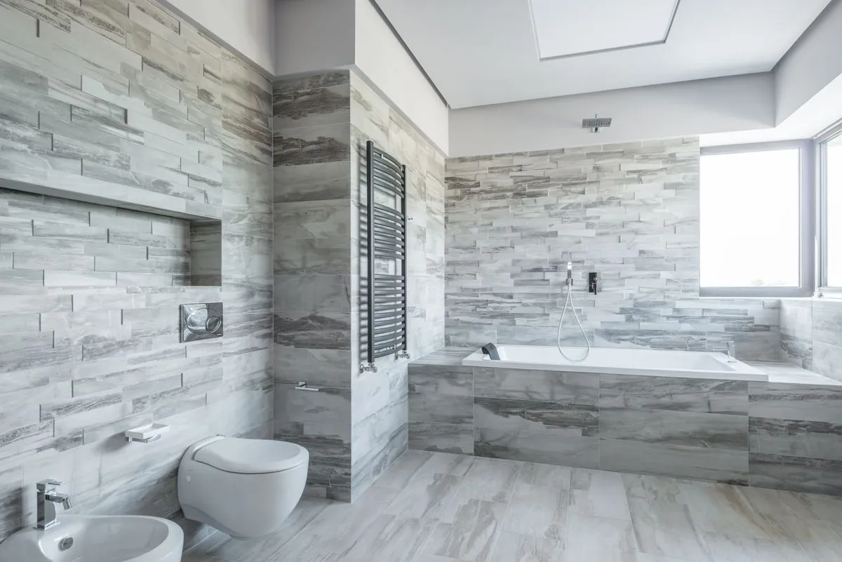 Finished shower wall tile with waterproof detailing and trim