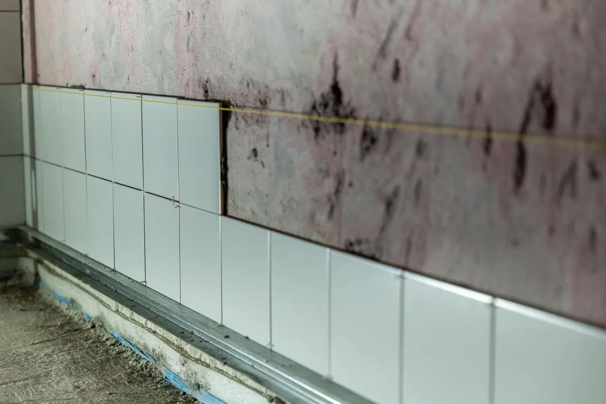 Tile installation contractor working on a modern bathroom floor