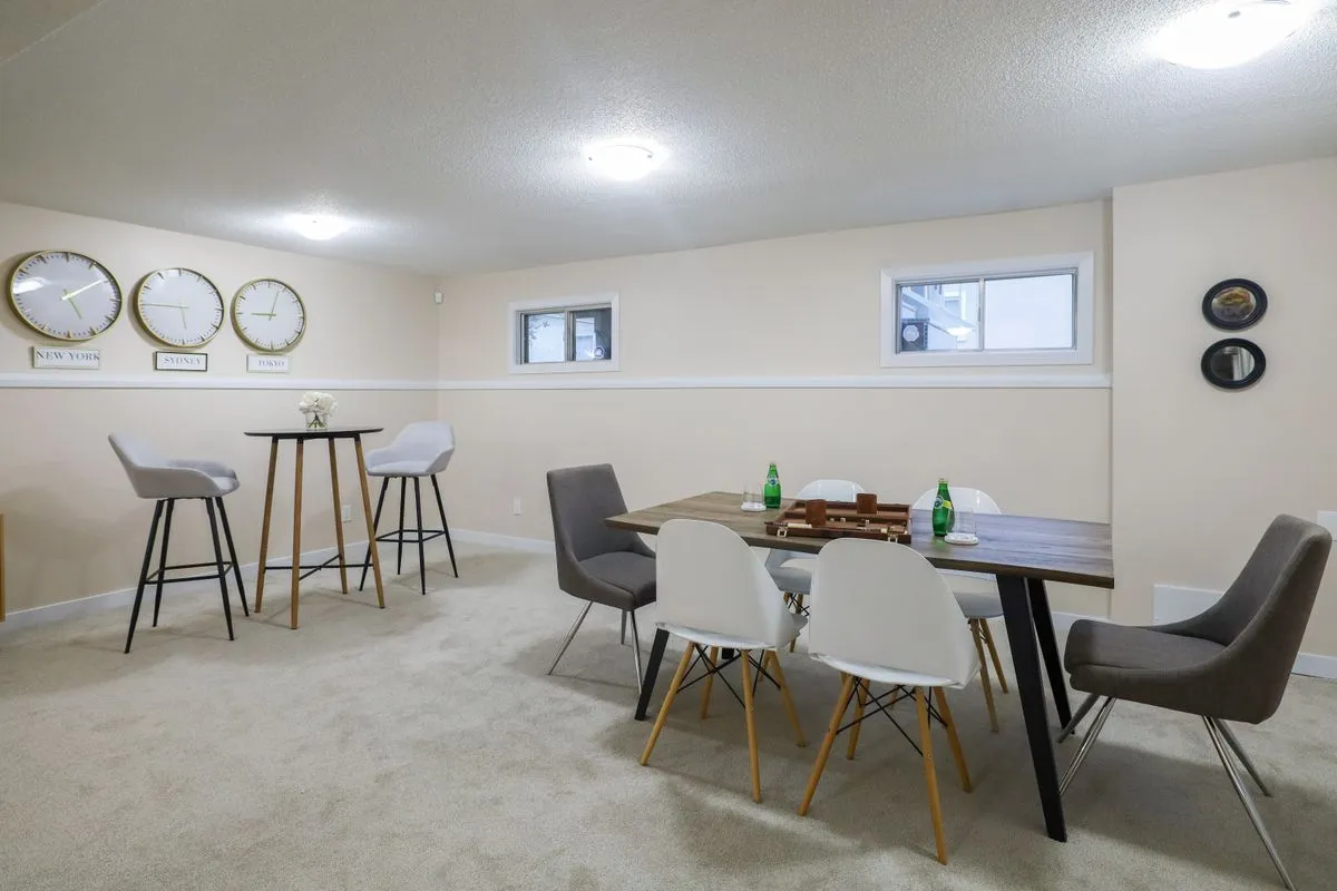 Finished basement living room with recessed lighting and a warm modern layout