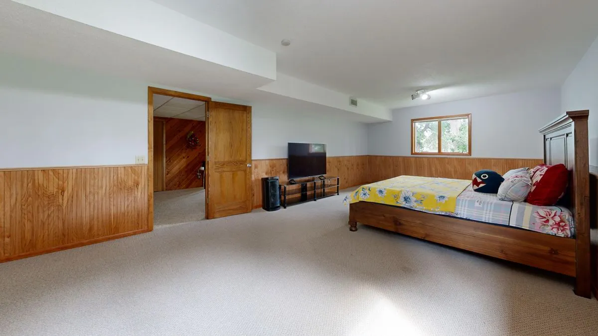 Finished modern basement living space with warm lighting and clean design