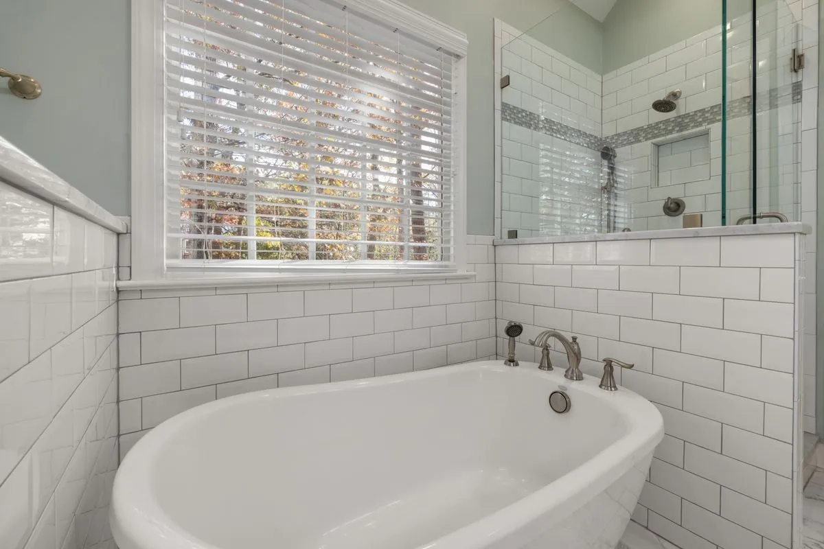 Bathroom remodeling project with a large walk-in shower and neutral tile