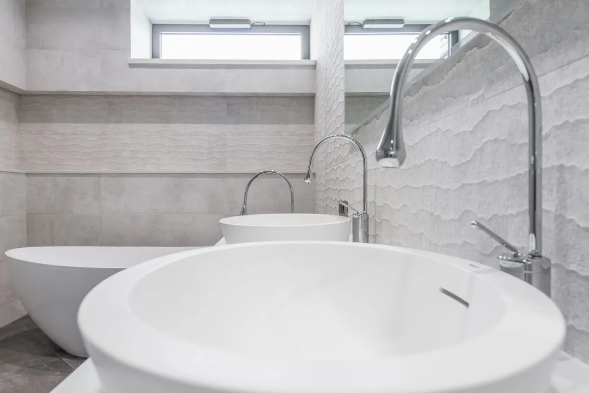 Modern bathroom remodeling project with walk-in shower, floating vanity, and tiled walls