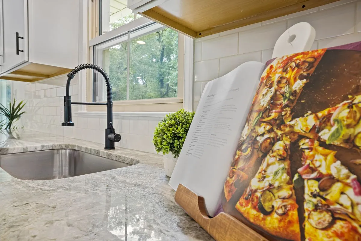 Modern kitchen renovation contractor result with island seating and pendant lights