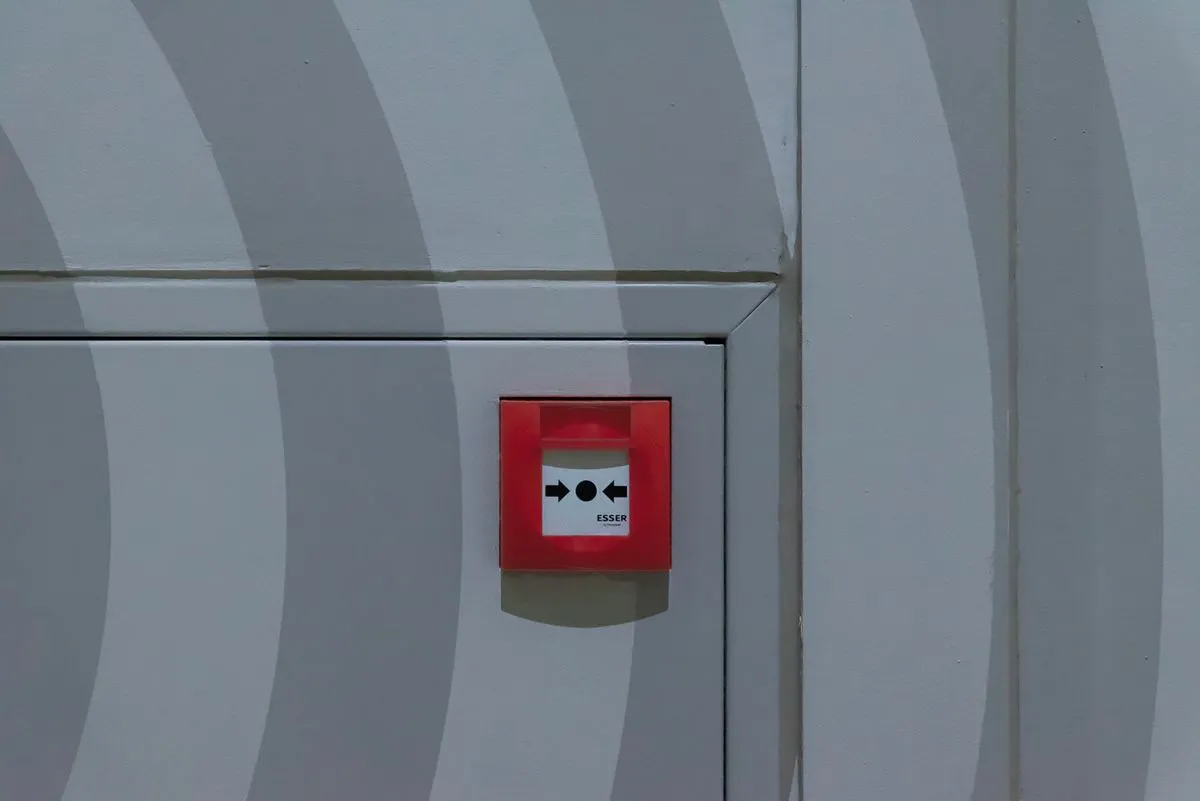 Technician installing a commercial security system in a business facility