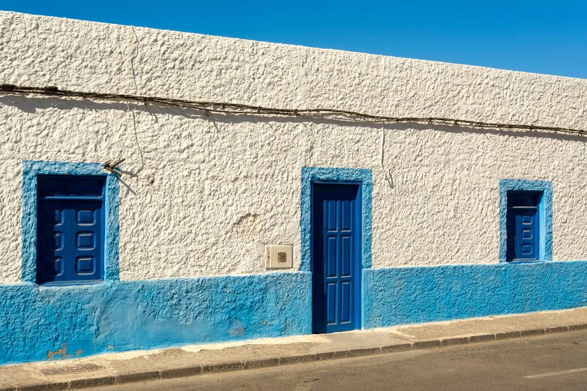 Fresh exterior house painting on a two-story home with white trim and navy siding