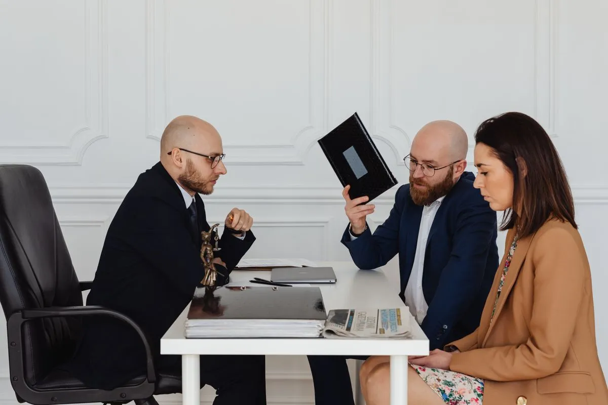 Employment lawyer reviewing workplace documents with a client