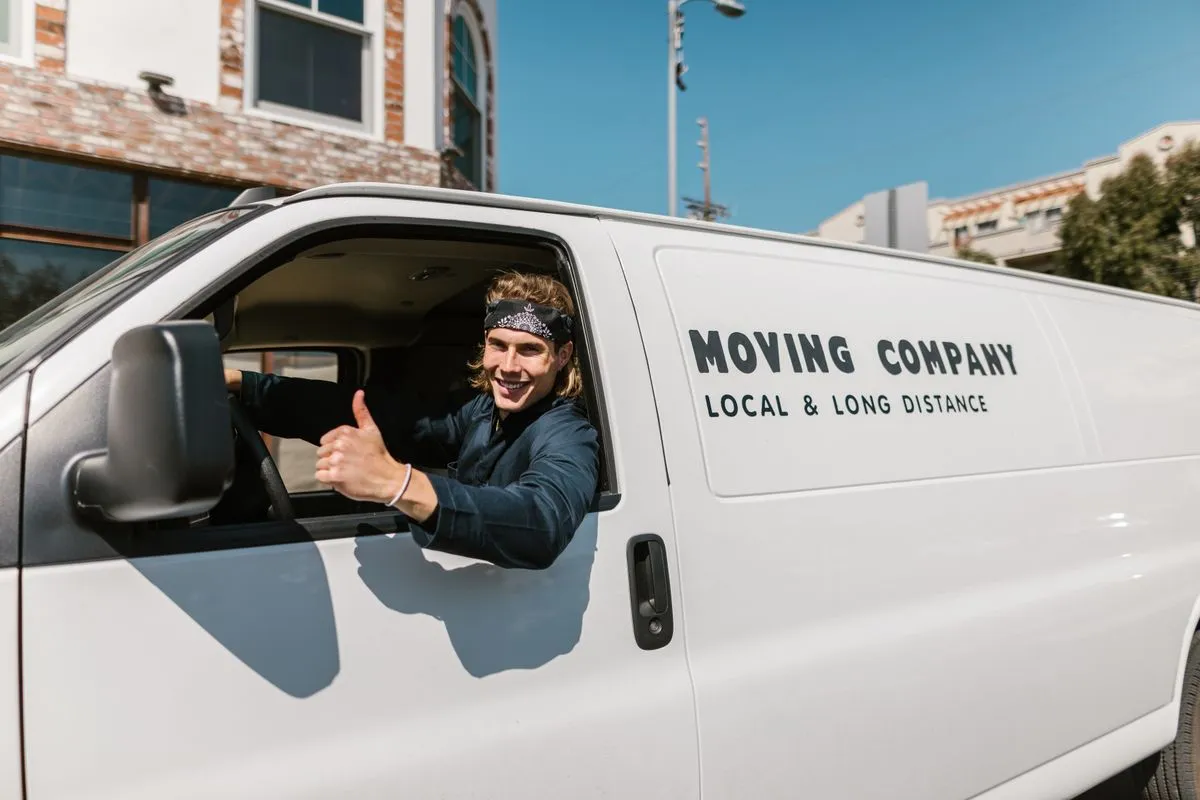 Movers wrapping a sofa before loading the truck