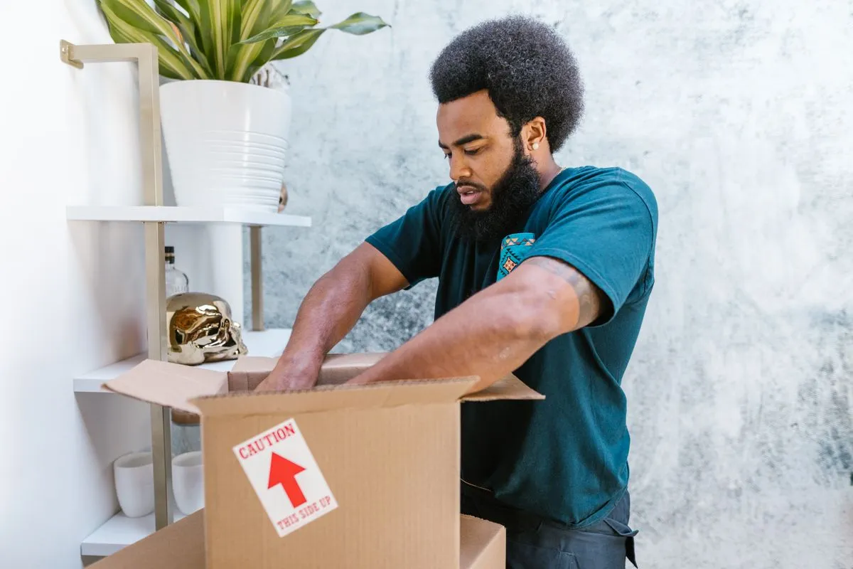 Professional movers loading boxes into a moving truck for a long distance relocation
