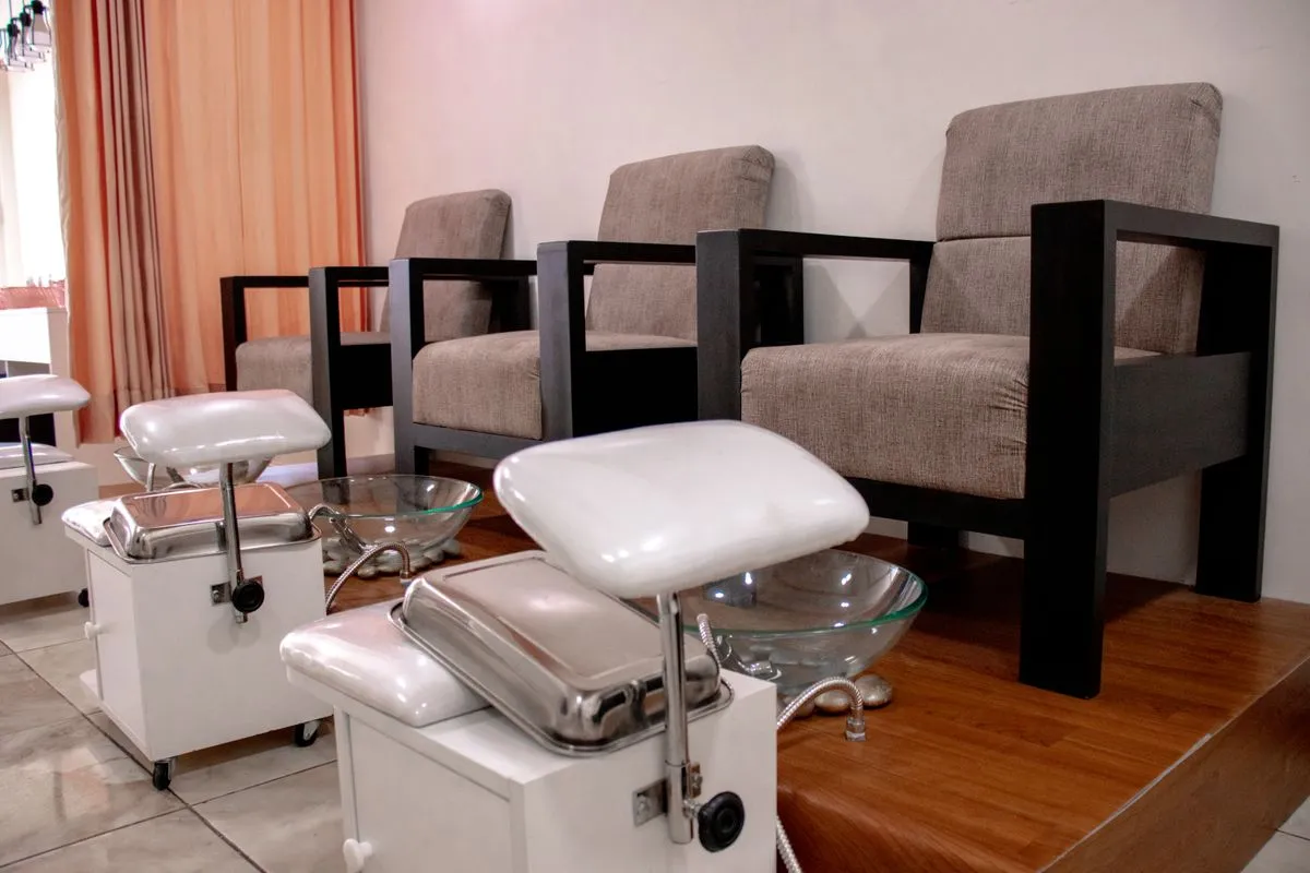 Elegant manicure and pedicure setup with glossy nails and fresh flowers