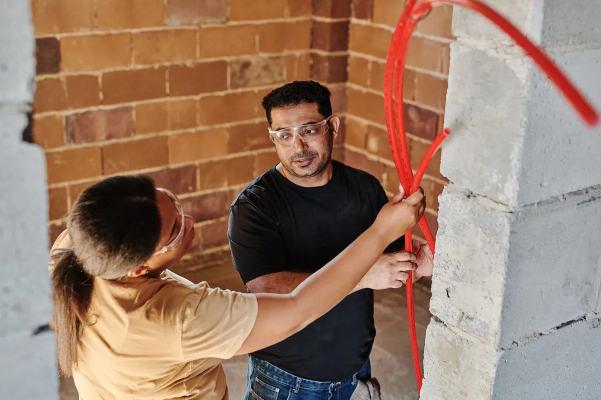 Emergency plumber inspecting a leaking water heater
