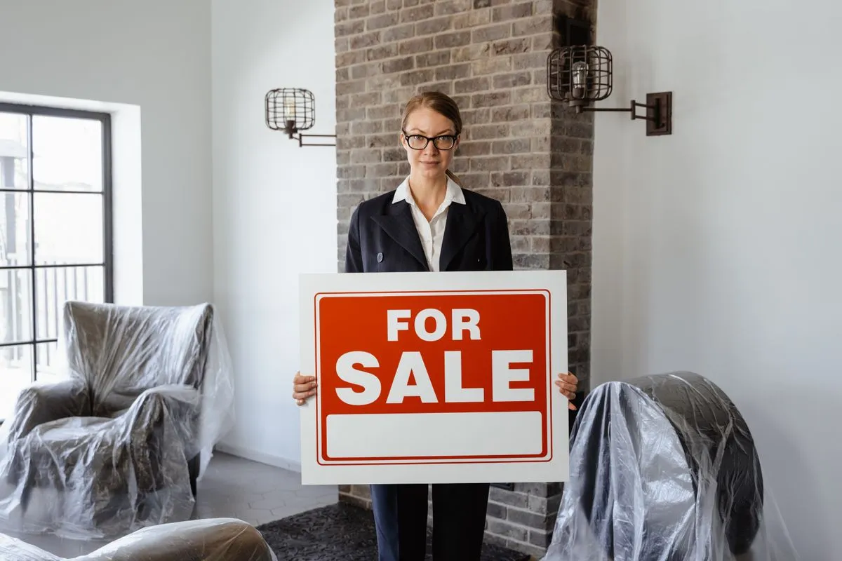 A homeowner reviewing a fast home sale offer with a real estate advisor